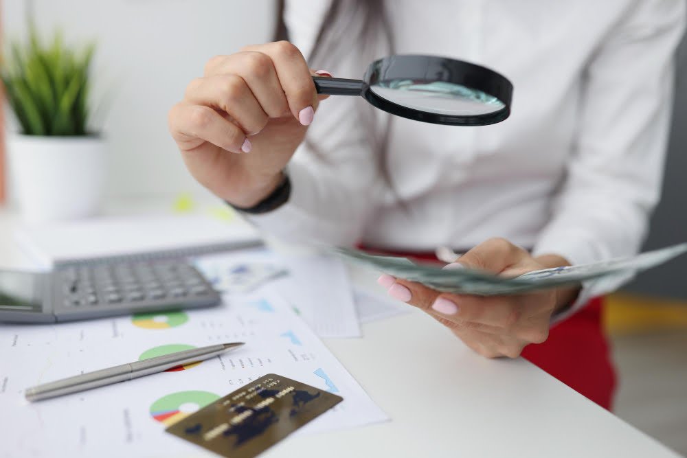 female-hold-magnifying-glass-analyzing-business-financial-data-manager-calculates-company-finances